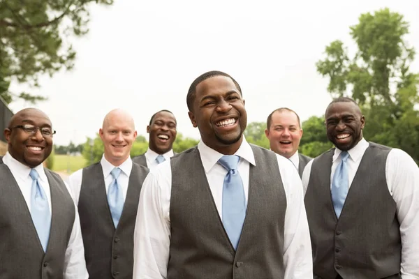 Bräutigam und Trauzeugen lächeln bei einer Hochzeit. — Stockfoto