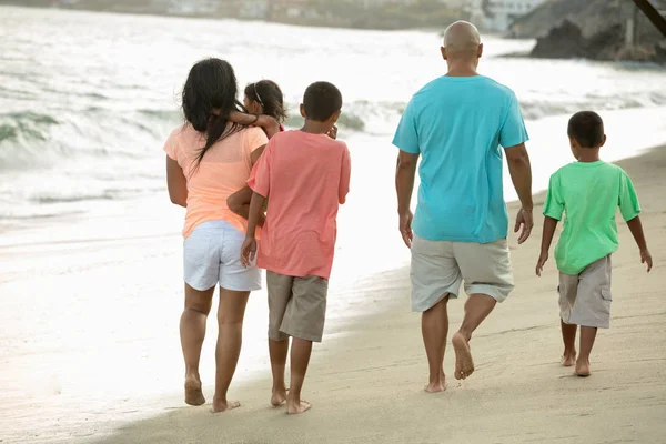 Familia caminando por la playa. — Foto de Stock