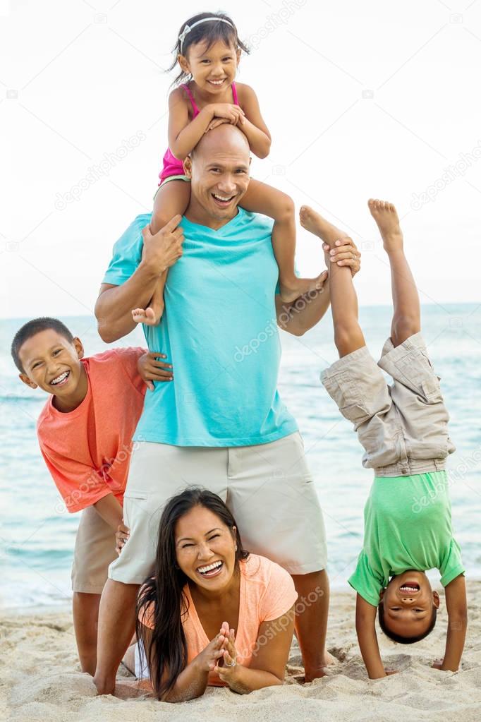 Happy family playing on the beach.