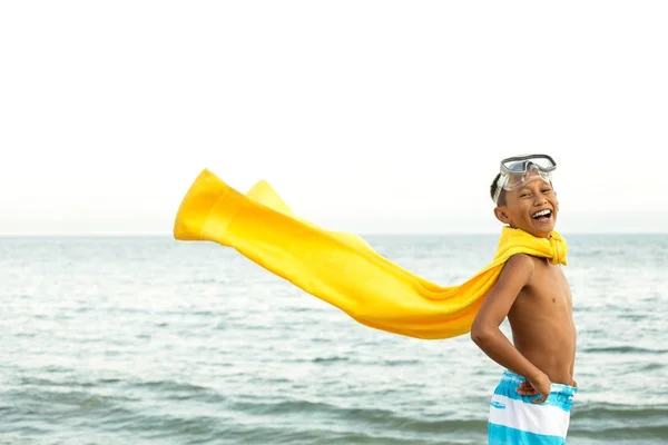 Young boy playing superhero on the beach. — Stock Photo, Image