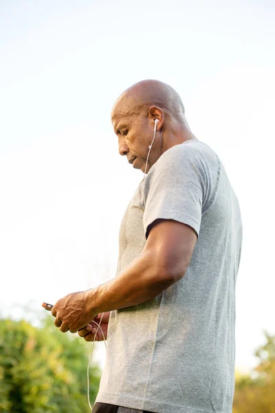 Fit African American man listening to music. — Stock Photo, Image