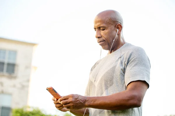 Fit African American man listening to music. — Stock Photo, Image