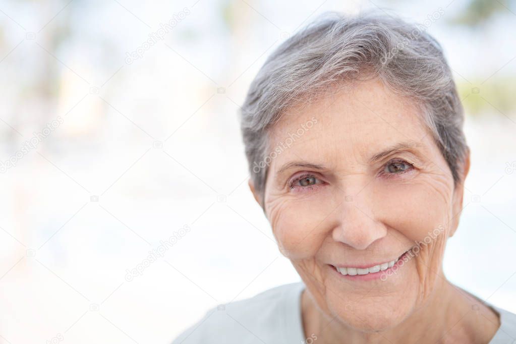 Portrait of a mature elderly woman smiling.
