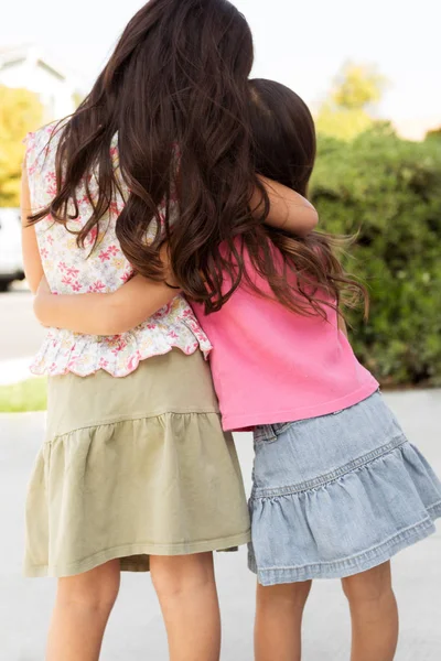 Cute little girls hugging. Sisters and best friends.