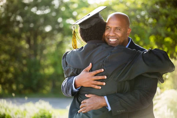 Father hugging his son at his graduation. — Stock Photo, Image