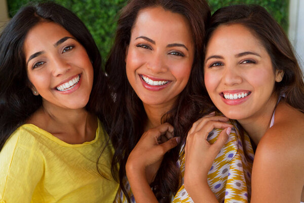 Beautiful Hispanic women smiling at the beach.