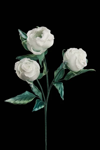 Artificial white rose on black background