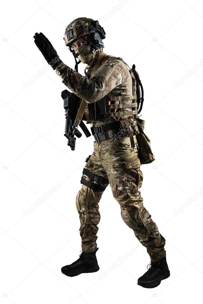 Soldier holding assault rifle. Uniform conforms to special services of the Russian Federation. Shot in studio. Isolated with clipping path on white background