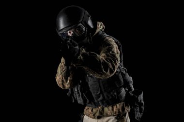 Bir asker saldırı tüfeği tutuyor. Üniforma Rusya Federasyonu 'nun FSB özel hizmetlerine uyuyor. Stüdyoda çekilmiş. Siyah arkaplanda kırpma yolu ile izole edildi