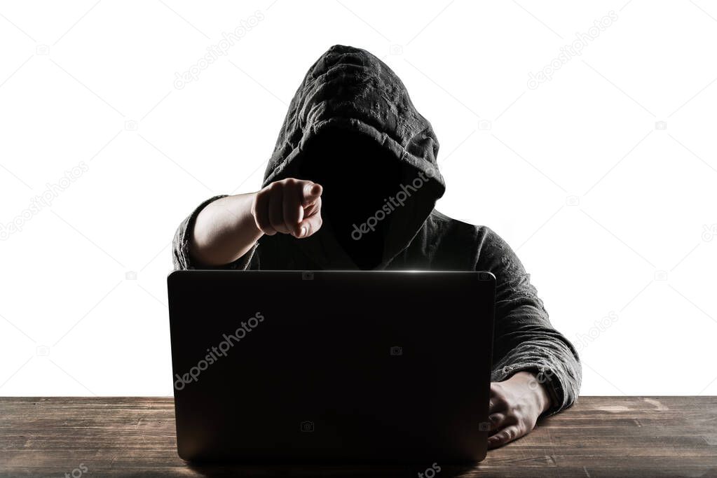 Hacker in front of his computer. Dark face. Isolated on white background