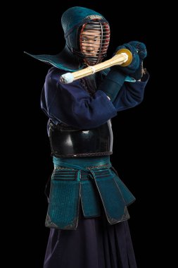 Shinai (bambu kılıcı) ile insan kendo dövüşçüsü portresi. Stüdyoda çekilmiş. Siyah arkaplanda kırpma yolu ile izole edildi