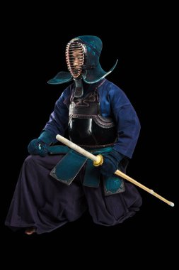 Shinai (bambu kılıcı) ile insan kendo dövüşçüsü portresi. Stüdyoda çekilmiş. Siyah arkaplanda kırpma yolu ile izole edildi