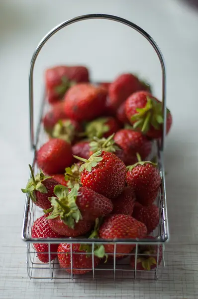 Strawberries in a small metal basket — Stock Photo, Image