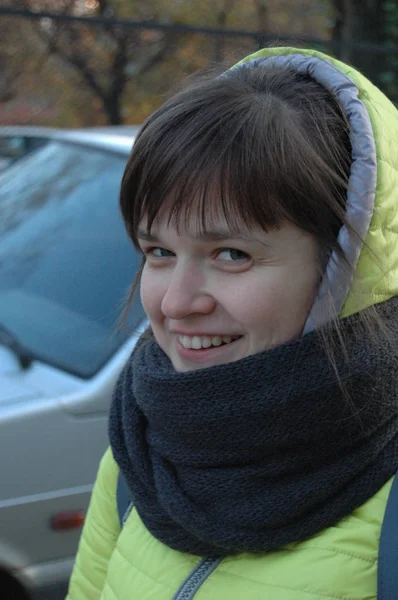 girl in a green jacket and with a warm scarf