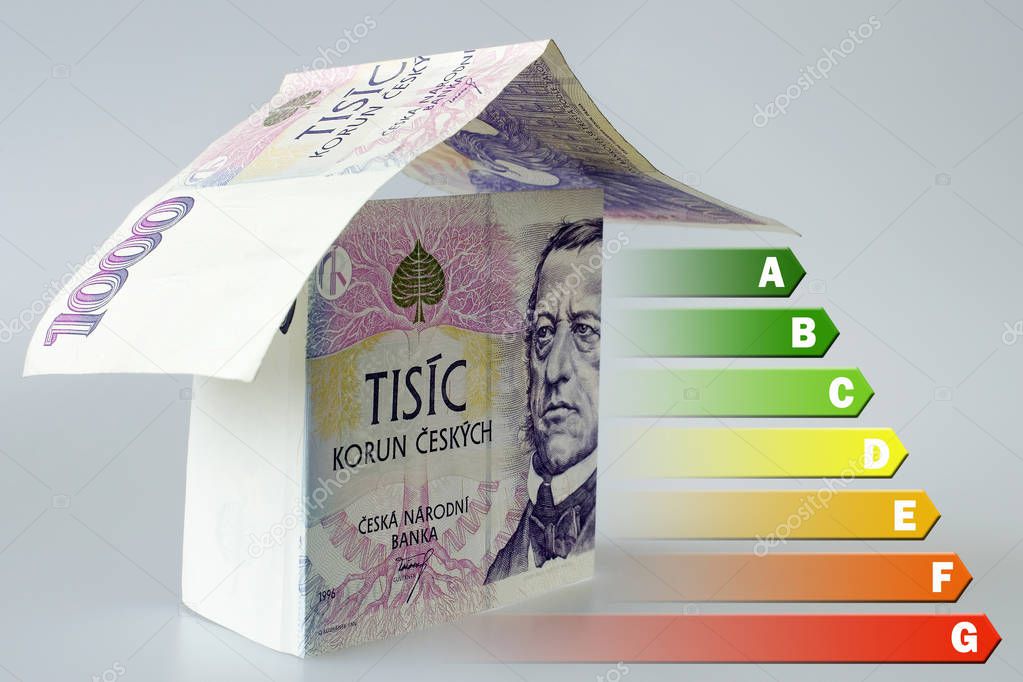 Energy efficiency label for house / heating and money savings - house made of Czech crown currency banknotes