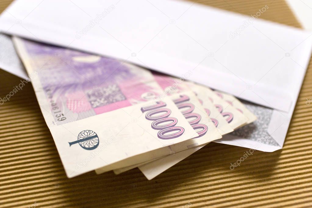 czech economy and finance - czech crown banknotes in a envelope - bribe and corruption concept