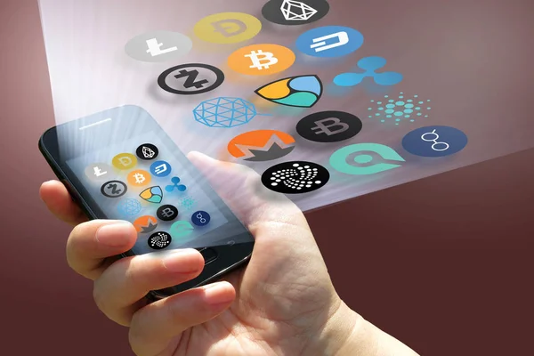 Virtual cryptocurrency - financial technology and internet money - smartphone in a hand and coin signs — Stock Photo, Image