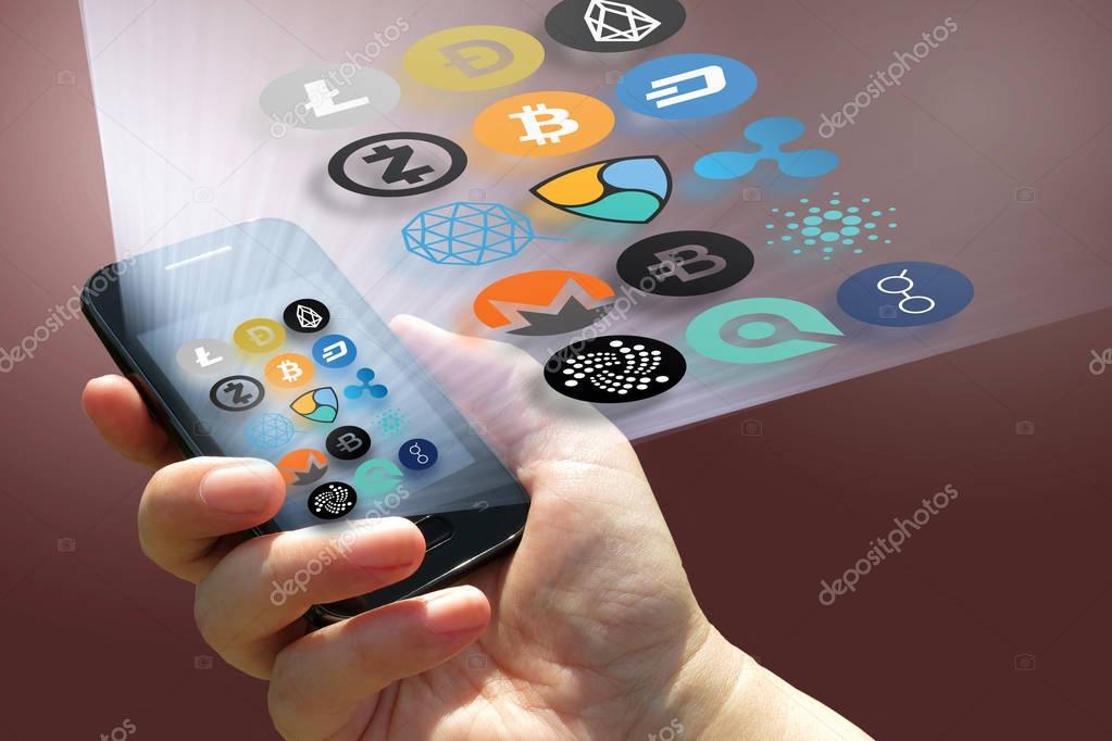 Virtual cryptocurrency - financial technology and internet money - smartphone in a hand and coin signs