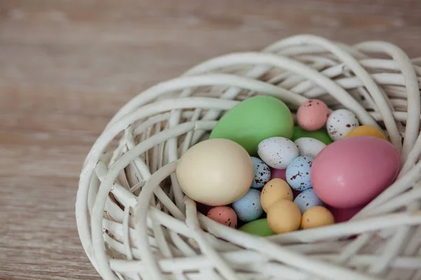 Multi-colored Easter eggs in the white nest