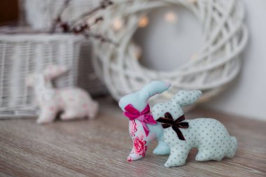 El yapımı paskalya tavşanları, beyaz ahşap arka planda, hafif bir iç mekanda.