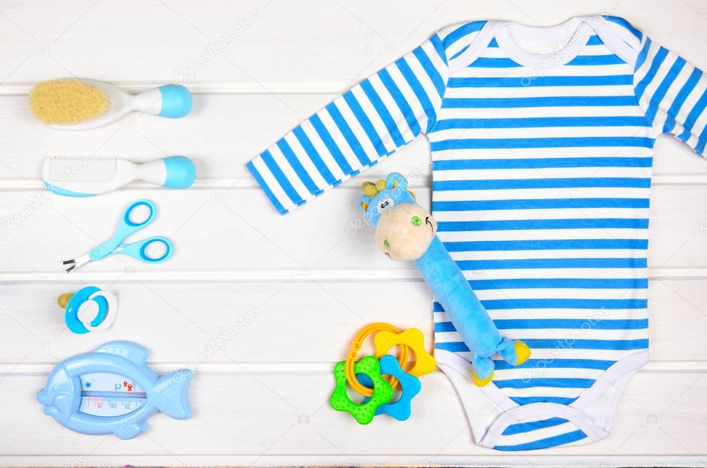 Baby accessories on white wood background