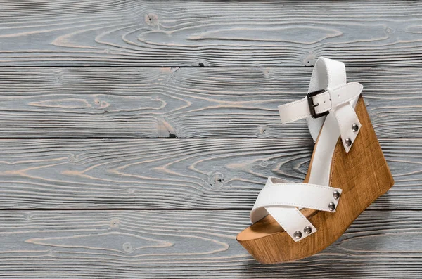 Womens shoes (crisscross wood platform wedges) on grey wooden ba — Stock Photo, Image