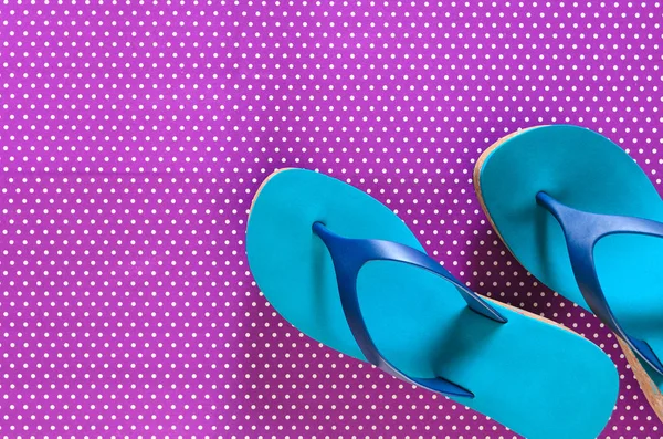 Womens shoes (blue green flip flops) on violet background in pol