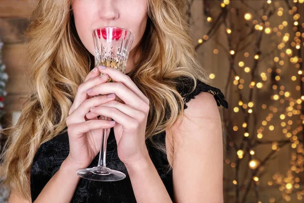 Bir kadeh şampanya, bokeh arka plan üzerinde ile genç sarışın kadının yakın çekim