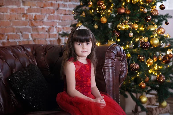 Cute Little Girl Red Dress Sitting Sofa Looking Camera Front — Stock Photo, Image