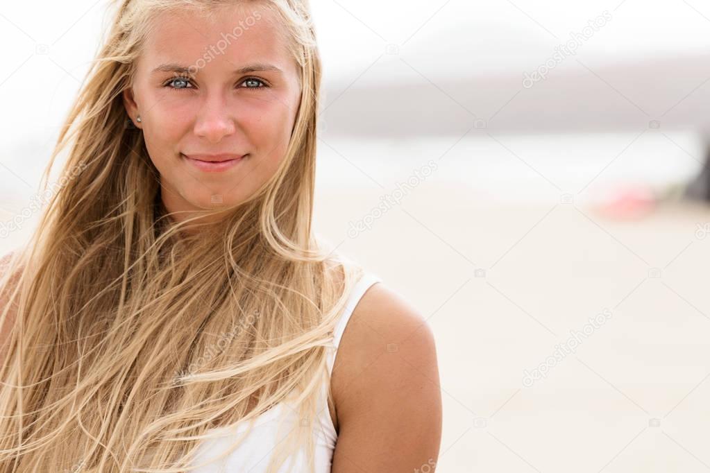 girl with blue eyes and blonde hair at the beach