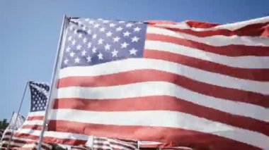 Amerikan bayrakları sallayarak bir mavi gökyüzü arka plan ile. Bağımsızlık günü