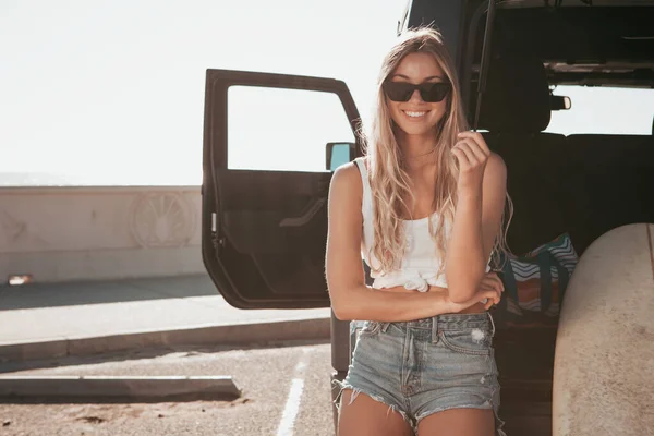 Surfer girl sitting at a car with surfboard. california lifestyle — Stock Photo, Image