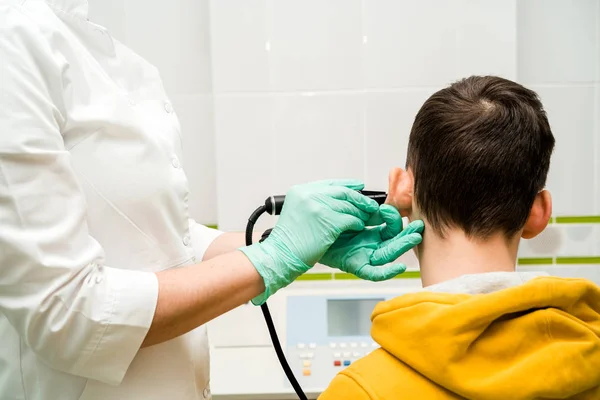 Preventive examination of a teenage boy in a medical facility.