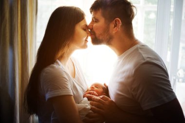 Father and mother with a newborn son. New multi generation young family