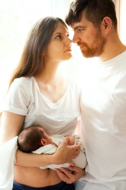 Father and mother with a newborn son. New multi generation young family