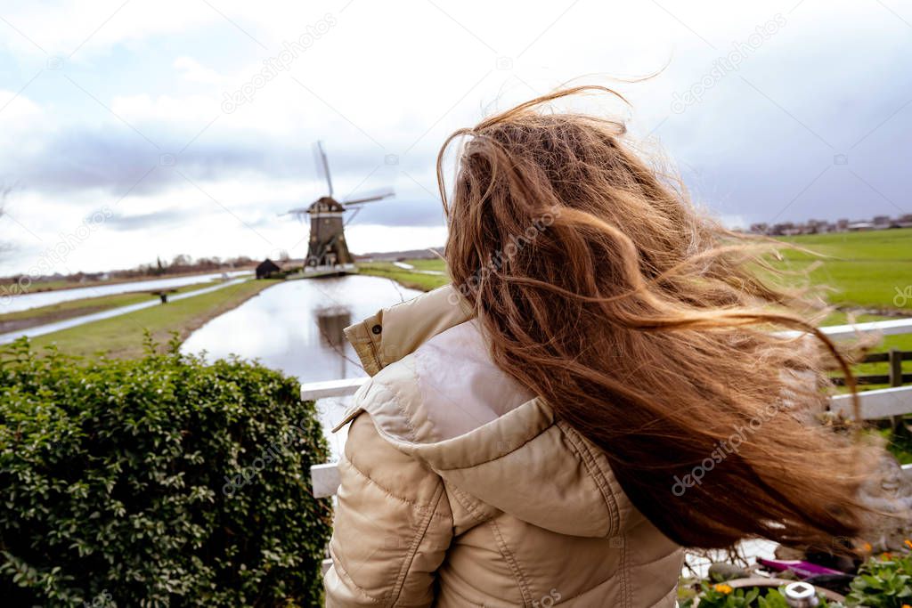 Girl with long red hair developing in the wind. 