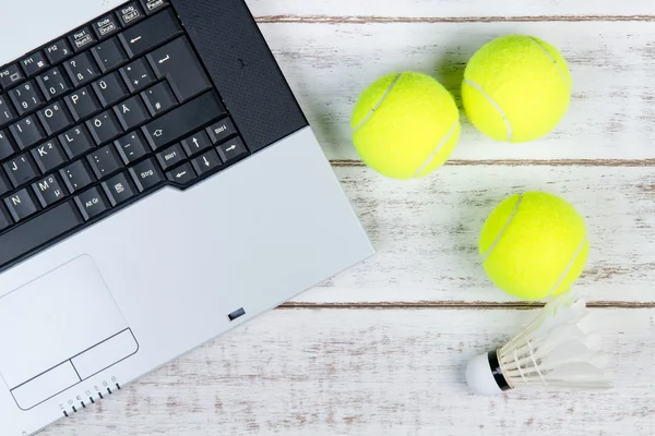 Top view of laptop, Sports Equipment, Tennis ball and Shuttlecoc