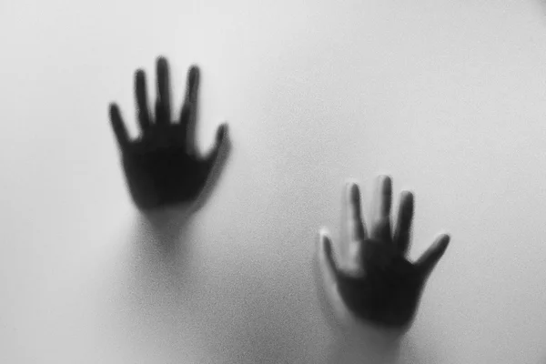 Shadow hands of the Man behind frosted glass. Blurry hand abstrac — стоковое фото