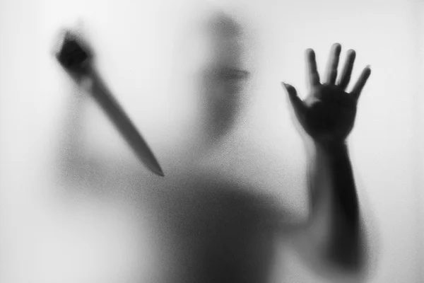 Horror Murderer. Dangerous man behind the frosted glass with a k — Stock Photo, Image