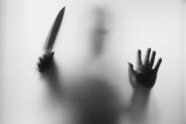 Horror Murderer. Dangerous man behind the frosted glass with a k — Stock Photo, Image