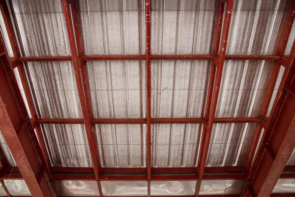 Under metal sheet attached to the roof insulation.