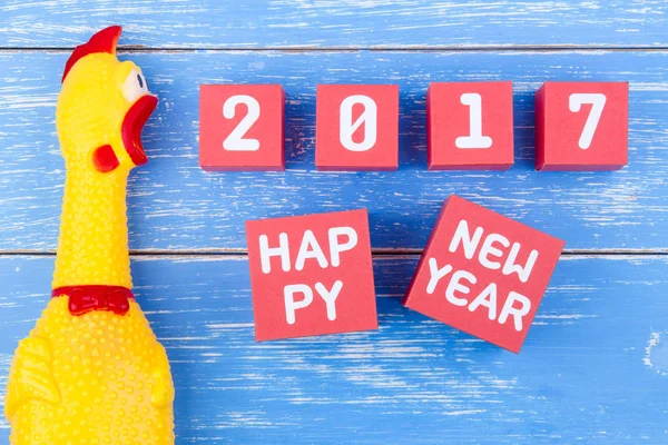 Toy yellow shrilling chicken and Happy new year 2017 number on r