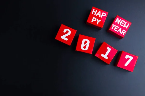 Happy new year 2017 number on red paper box cubes on black backg — Stock Photo, Image