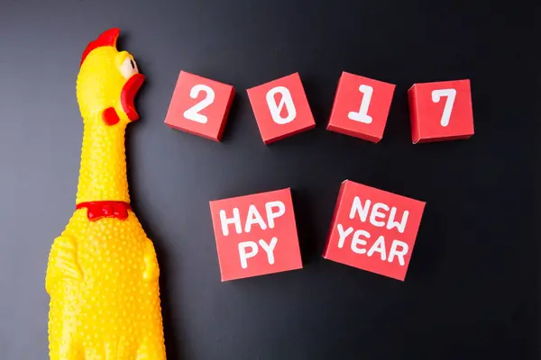 Toy yellow shrilling chicken and Happy new year 2017 number on r