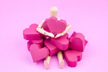 Kağıt kutusu kırmızı kalp şekli üzerinde pembe adam tutarak ahşap kukla
