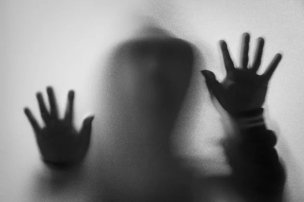 Shadow blur of horror man in jacket with hood.Hands on the glass — Stock Photo, Image