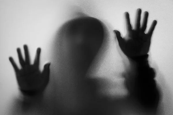 Shadow blur of horror man in jacket with hood.Hands on the glass — Stock Photo, Image