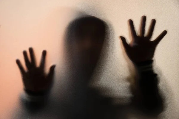 Shadow blur of horror man in jacket with hood.Hands on the glass — Stock Photo, Image