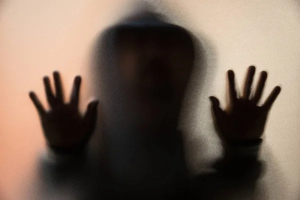 Shadow blur of horror man in jacket with hood.Hands on the glass — Stock Photo, Image