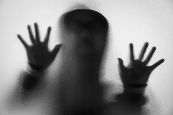 Shadow blur of horror man in jacket with hood.Hands on the glass — Stock Photo, Image